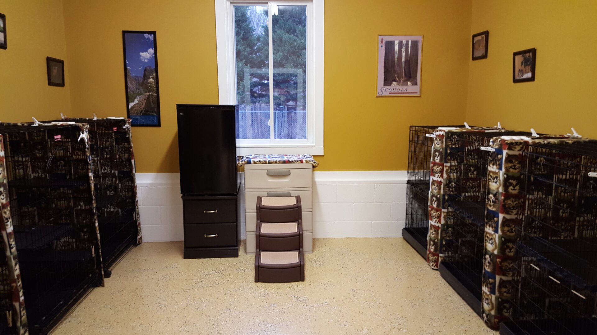 A room with two boxes and a refrigerator.